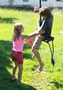 Wet boy and girl on a swing Royalty Free Stock Photo