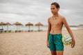 Wet boy holding volleyball ball on the beach Royalty Free Stock Photo