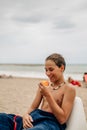 Wet boy looking at apricot on the beach Royalty Free Stock Photo