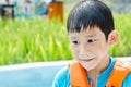 Wet boy wearing blue life jacket