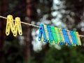Wet bright multicolored clothespins after a rain. Royalty Free Stock Photo