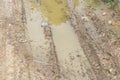 Wet brown mud with bicycle tyre tracks Royalty Free Stock Photo