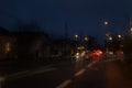 Wet car window with the background of the night city traffic rain fall at night with blurry cars Royalty Free Stock Photo