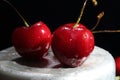 Wet cherries on a black background. Royalty Free Stock Photo