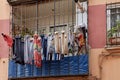 Wet clothes are dried outside window on  facade Royalty Free Stock Photo