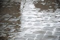 Wet cobblestones at night after rain on a street or road surface Royalty Free Stock Photo