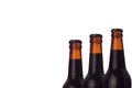 Wet cold brown dark beer bottles closeup, half bottle view, isolated on white background. Royalty Free Stock Photo
