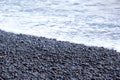 Wet dark pebbles and rocks on the ocean coast