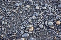 Wet dark pebbles and rocks on the ocean coast