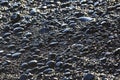 Wet dark pebbles and rocks on the ocean coast