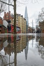 Wet day in London Borough for Southwark with reflections in pavement puddle