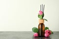 Wet diffuser bottle with sticks and pink roses Royalty Free Stock Photo