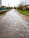 wet dirty gravel road in village after rain