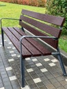 Wet empty wooden bench with rain drops in Royalty Free Stock Photo