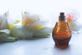 female perfume with flowers on light background Royalty Free Stock Photo