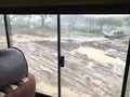 Wet flooded road. Soil erosion after storm, view thru four-wheel drive at Serengeti National Park in Tanzania, Africa Royalty Free Stock Photo