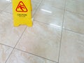 Wet floor with caution slippery sign. Incident warning. Office worker safety Royalty Free Stock Photo