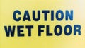 Wet Floor Caution text as a sign or symbol