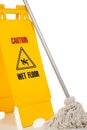 Wet floor sign and mop on white background Royalty Free Stock Photo