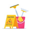 Wet floor warning sign. Yellow triangle with falling man. Cleaning service supplies. Disinfectant products with bucket, mop, Royalty Free Stock Photo