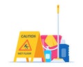 Wet floor warning sign. Yellow triangle with falling man. Cleaning service supplies. Disinfectant products with bucket, mop, Royalty Free Stock Photo