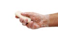 Wet foamed hand holding soap isoalted on white background