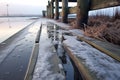 wet footprints on a frosty wooden jetty