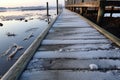 wet footprints on a frosty wooden jetty