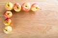 Wet fuji apple on wood chop block and on wood table