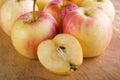 Wet fuji apple on wood chop block and on wood table