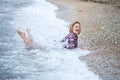 Wet girl lying in the water on the sea beach Royalty Free Stock Photo