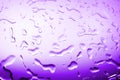 Wet glass in drops of water or rain, bright purple color, studio light, gradient, wet mirror surface texture background close up Royalty Free Stock Photo