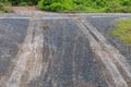 Wet gravel road with car wheel trace. Royalty Free Stock Photo