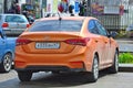 Wet Hyundai Solaris 1.6 Orange in Russia. Royalty Free Stock Photo