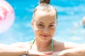 Wet kid face portrait happy smiling in outdoor pool on sunny summer day, girl Royalty Free Stock Photo