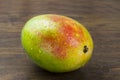 Wet mango ripe fresh red green yellow natural vitamins tropical life on wood