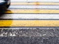Wet yellow and white striped pedestrian crossing Royalty Free Stock Photo
