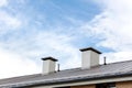 Wet metal roof with chimneys against blue cloudy sky Royalty Free Stock Photo