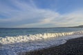 Wet pebbles of various shapes, sizes, colors and textures and a sea wave on a shingle beach in Mediterranean Sea Royalty Free Stock Photo