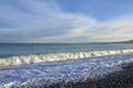 Wet pebbles of various shapes, sizes, colors and textures and a sea wave on a shingle beach in Mediterranean Sea Royalty Free Stock Photo