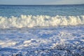 Wet pebbles of various shapes, sizes, colors and textures and a sea wave on a shingle beach in Mediterranean Sea Royalty Free Stock Photo