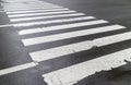 Wet pedestrian crosswalk on city street, safety concept.