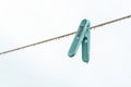 A wet plastic cloth clip on clothesline on rainy day Royalty Free Stock Photo