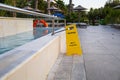 Wet pool floor warning. Yellow warning sign with the words wet floor