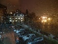 Wet rain glass in the evening against the backdrop of the courtyard with cars