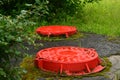 2 wet red manholes cover of fire hydrant