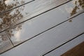 Wet with reflections garden decking. Deck board, diagonal laying. Wood plastic composite decking boards. Decking board, diagonal Royalty Free Stock Photo
