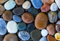 Wet round colorful stones on the bank of Baikal lake.