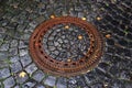 Rusty manhole cap, grunge manhole cover after rain