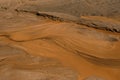 Minimalism background. Wet sand and beautiful streaks from the water top view. Natural sand looks as if someone turned over and Royalty Free Stock Photo